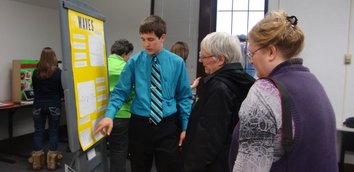 Students and visitors at a school project showcase